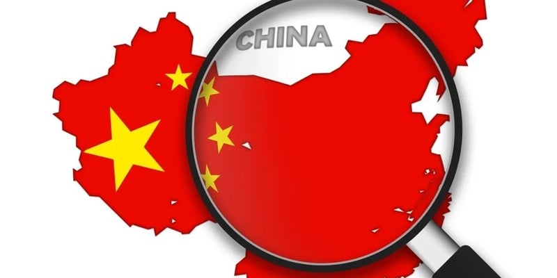 A magnifying glass hovering over a map of China.